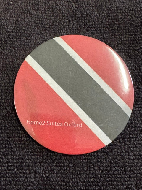 Trinidad Tribute Button – Home2 Suites Oxford Edition